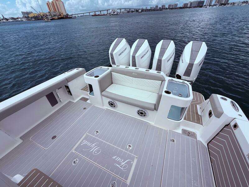 2024 Scout 400 LXF boat deck with seating and multiple Mercury engines.