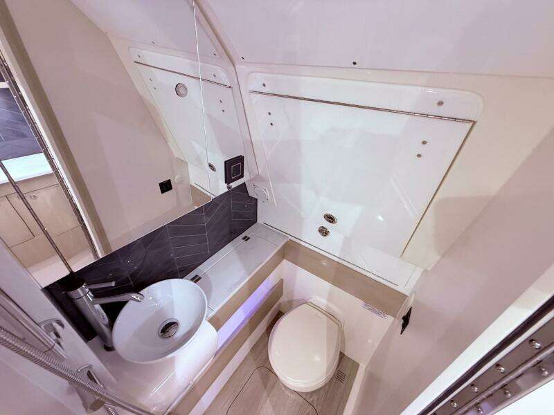Luxurious bathroom interior of 2024 Scout 400 LXF boat, featuring modern sink and toilet.