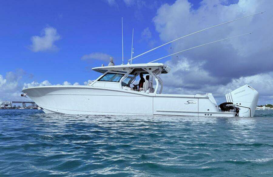 2024 Scout 400 LXF boat on water under blue sky.