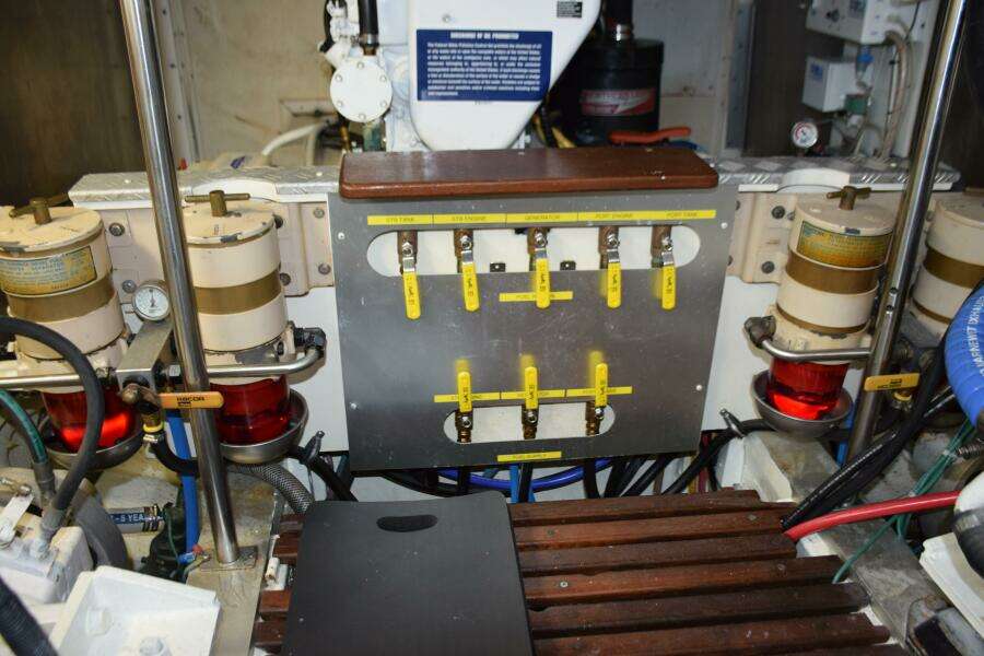 Engine Room Of A 1997 Grand Banks Classic Yacht With Fuel Filters And Control Panel.