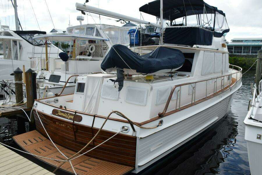 1997 Grand Banks Classic Yacht Docked, Featuring Elegant Wooden Details And Covered Upper Deck.