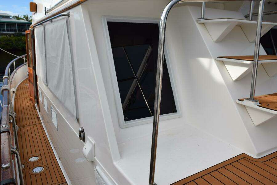 1997 Grand Banks Classic Yacht Deck With Wooden Flooring And Metal Railings.