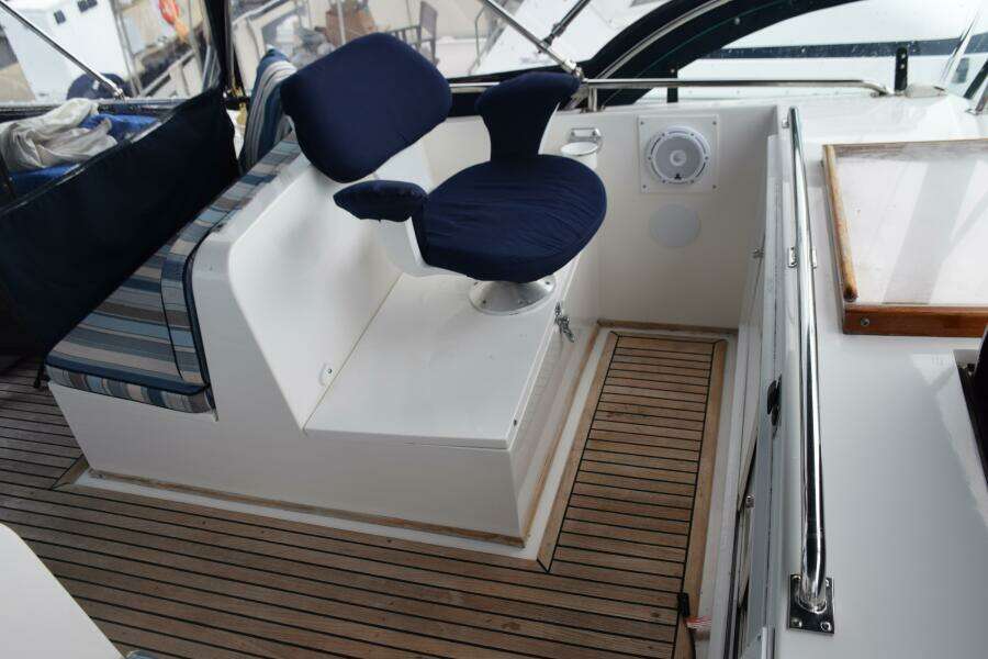 1997 Grand Banks Classic Boat Interior With Blue Cushioned Seating And Wooden Flooring.
