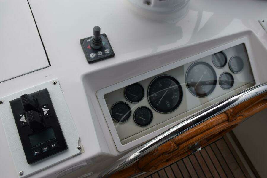 Control Panel Of A 1997 Grand Banks Classic Boat With Gauges And Switches.