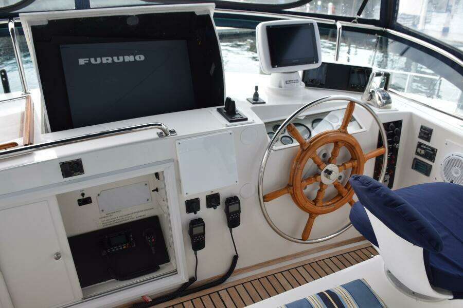 1997 Grand Banks Classic Helm With Wooden Wheel, Navigation Equipment, And Furuno Display.
