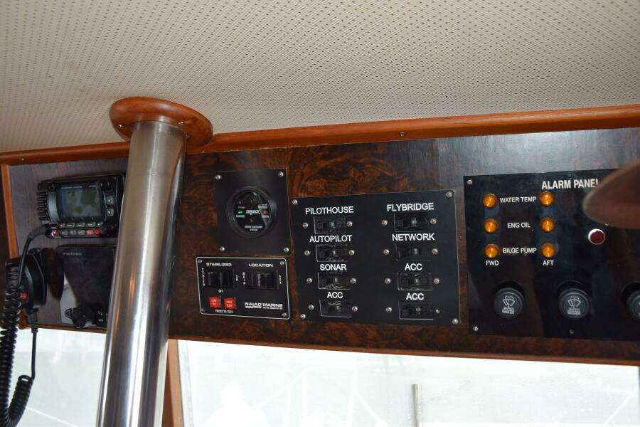 Control Panel Of A 1997 Grand Banks Classic Boat With Various Switches And Indicators.