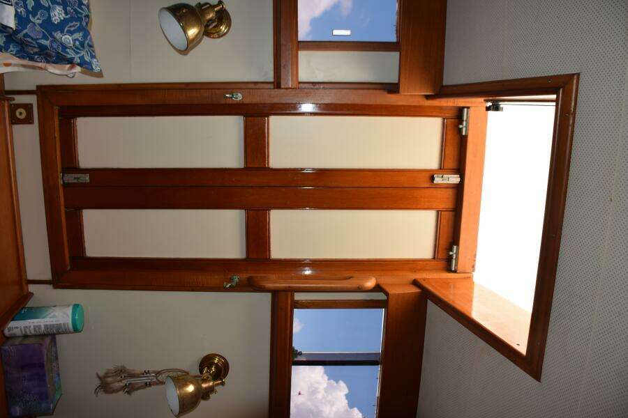    Interior Of 1997 Grand Banks Classic Yacht With Wooden Hatch And Brass Lighting.