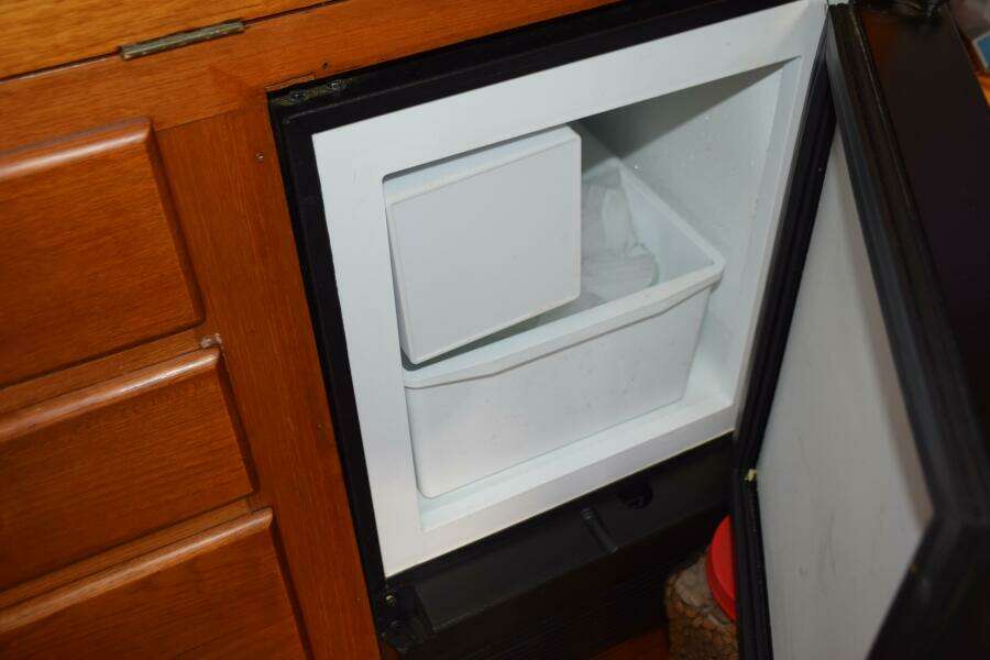 Ice Maker Inside A 1997 Grand Banks Classic Boat's Wooden Cabinet.