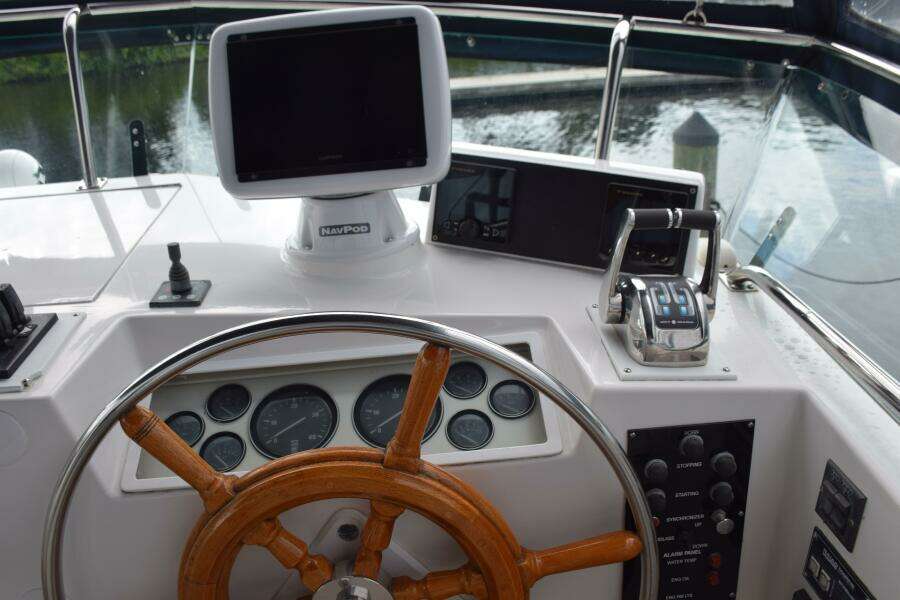 1997 Grand Banks Classic Helm With Wooden Wheel, Gauges, And Navigation Equipment.
