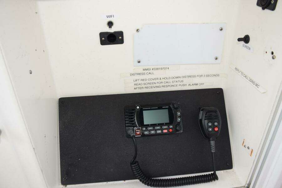 VHF Radio System On A 1997 Grand Banks Classic Boat, Featuring Distress Call Instructions.