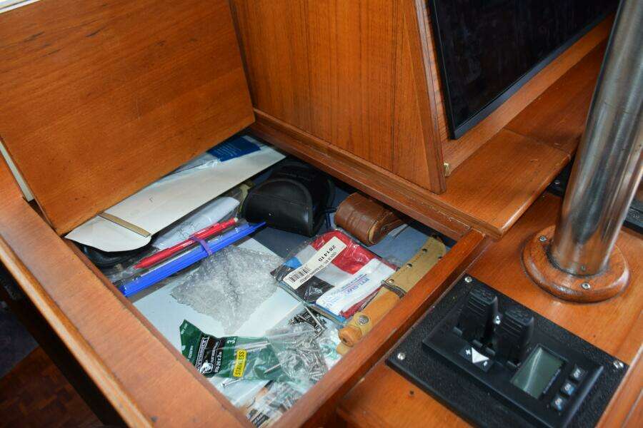 Interior Storage Compartment On A 1997 Grand Banks Classic Boat With Various Items.