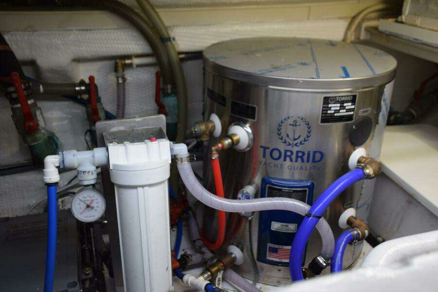 Engine Room Of 1997 Grand Banks Classic With Torrid Yacht Water Heater System.