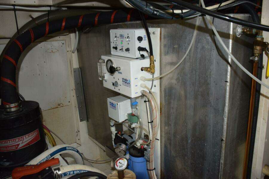 Engine Room Of A 1997 Grand Banks Classic Boat With Water Filtration System.