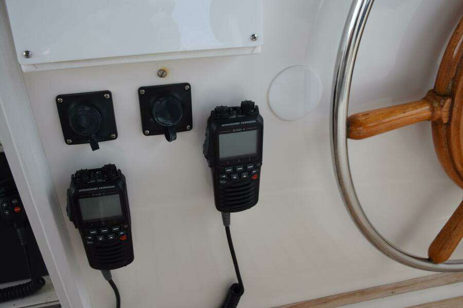 1997 Grand Banks Classic Boat Helm With Radios And Wooden Steering Wheel.