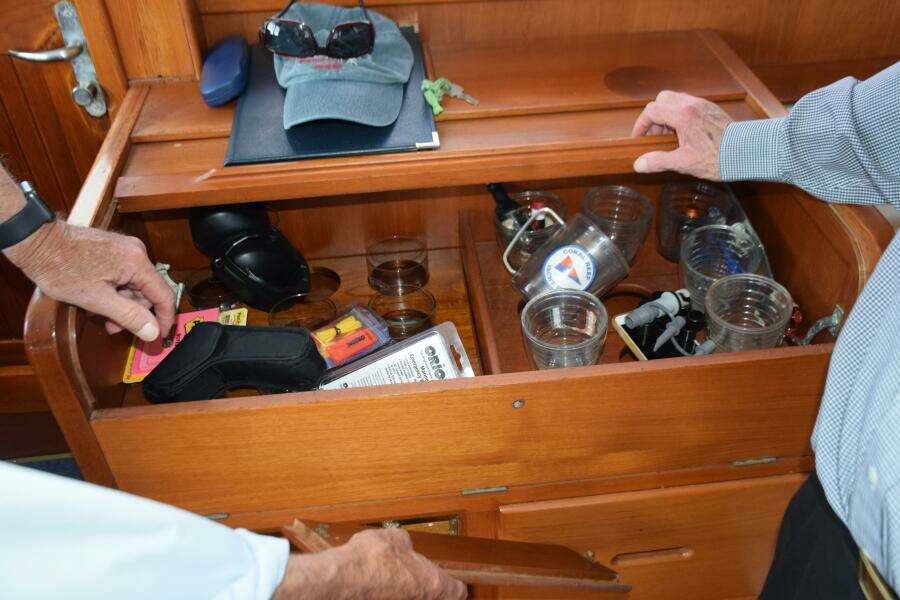Interior Of A 1997 Grand Banks Classic Boat With Open Wooden Storage Compartment.