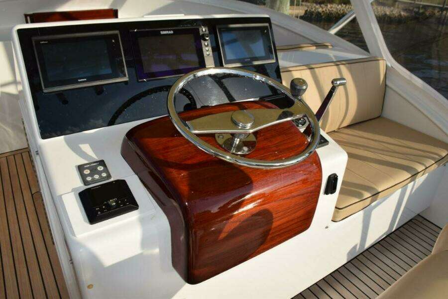 Custom Helm Wheel With Speed Knob, Newer Garmin Displays With A Simrad MFD In Center (displays Engine Gauges).