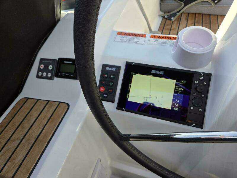 Port-side helm station with thruster, auto-pilot, engine panel, and B&G chart plotter