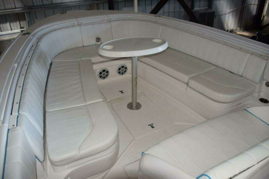 Forward Seating And Fiberglass Table With Drink Holders. Storage Compartments Behind Backrests.