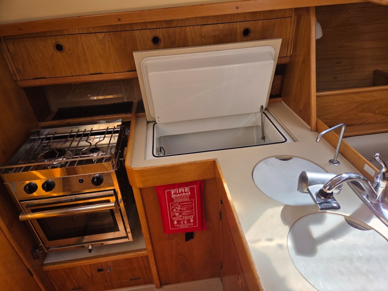 Galley with stove/oven, fridge, sink, and storage