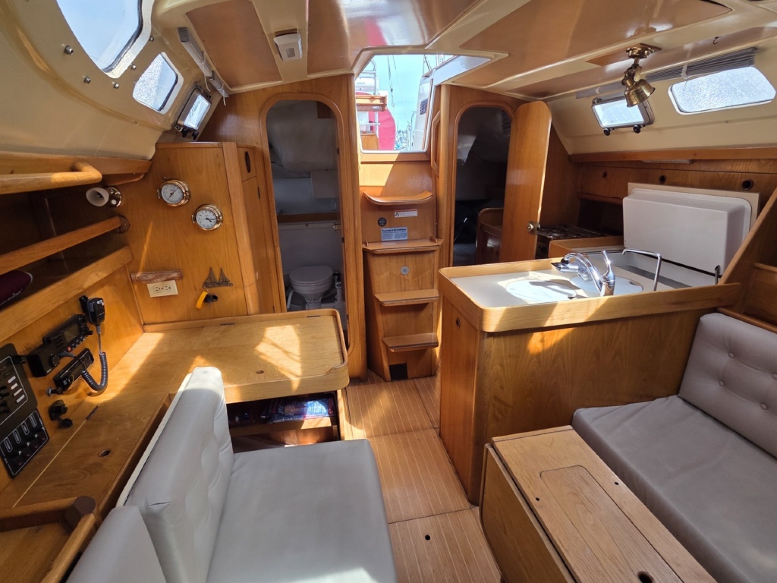 Interior of 1988 Beneteau Oceanis 350 with wooden finishes looking aft