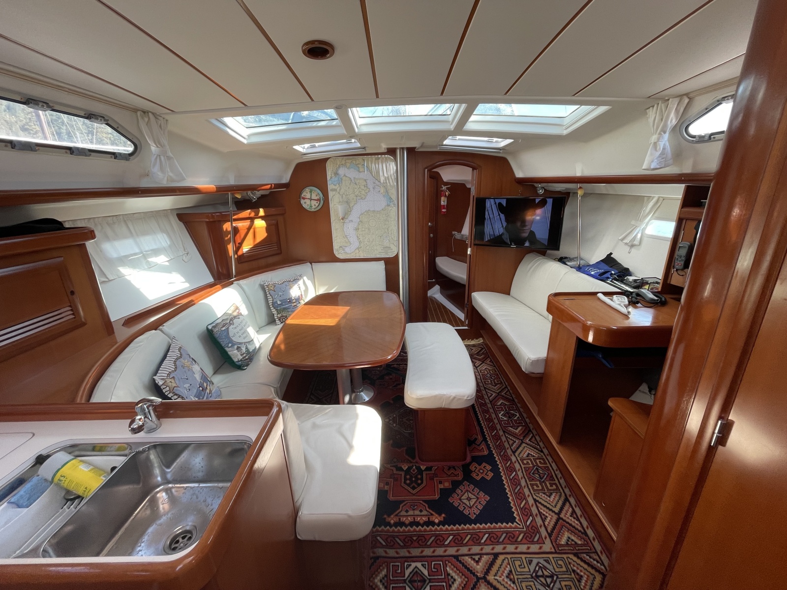 Luxurious interior of a 2007 Beneteau 393 yacht with elegant wood finish and cozy seating