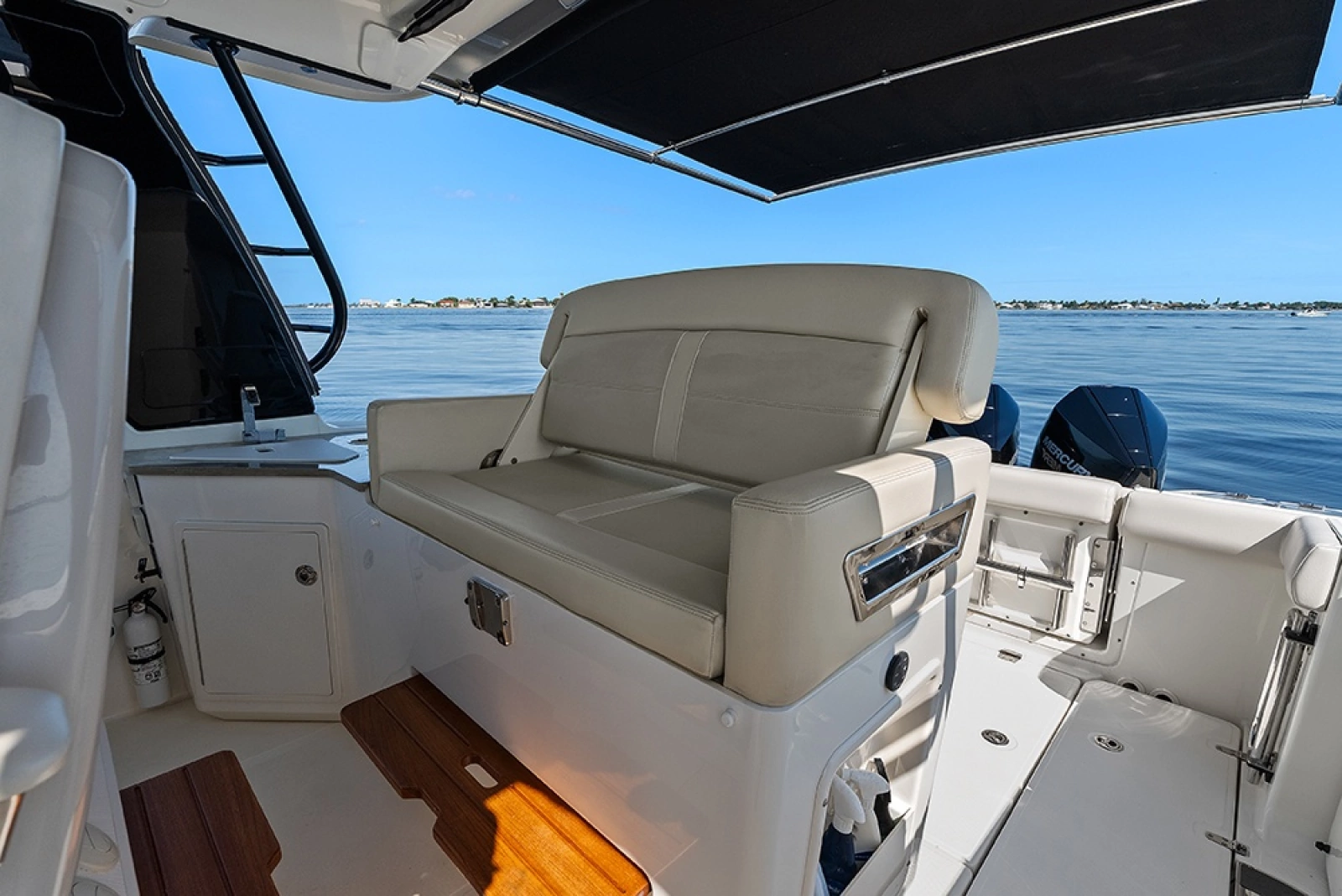 Helm deck second row seat with a conversation seatback