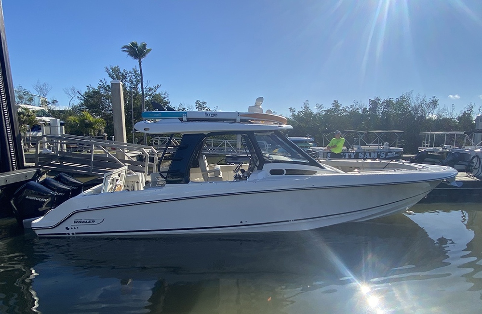 2023 Boston Whaler 350 Realm boat docked in a sunny marina setting.