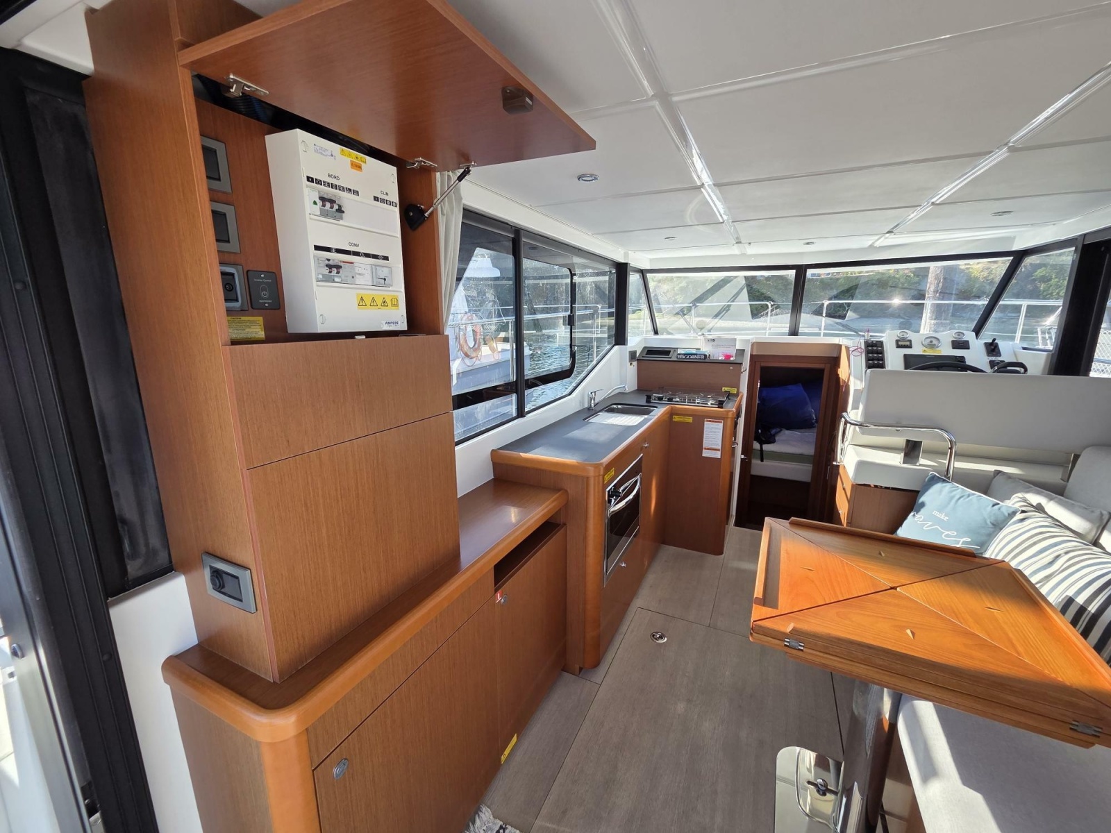 Interior of 2020 Beneteau Swift Trawler 30, featuring large galley and seating with custom table