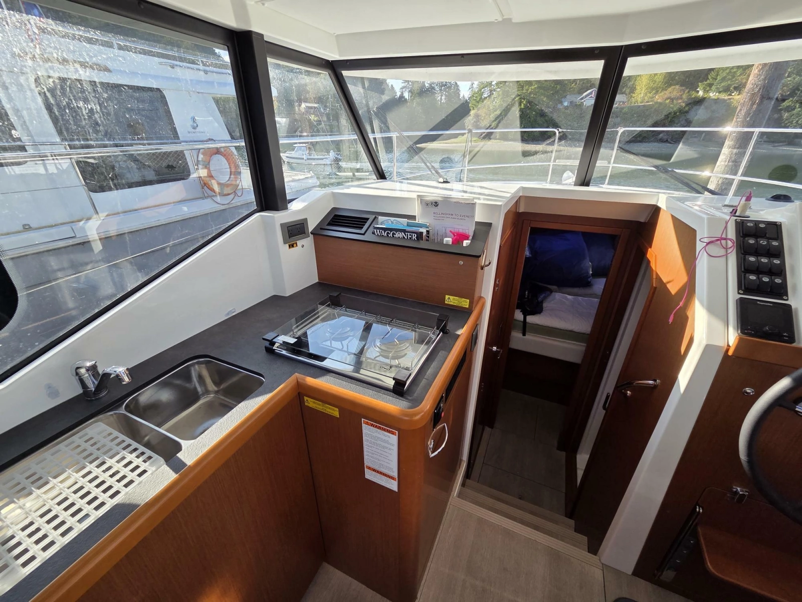 Galley with double sink, two fridges, oven, and dual burner propane cooktop