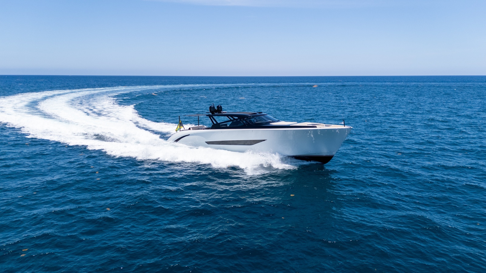 2025 Wajer 77 yacht cruising on open sea under clear blue sky.