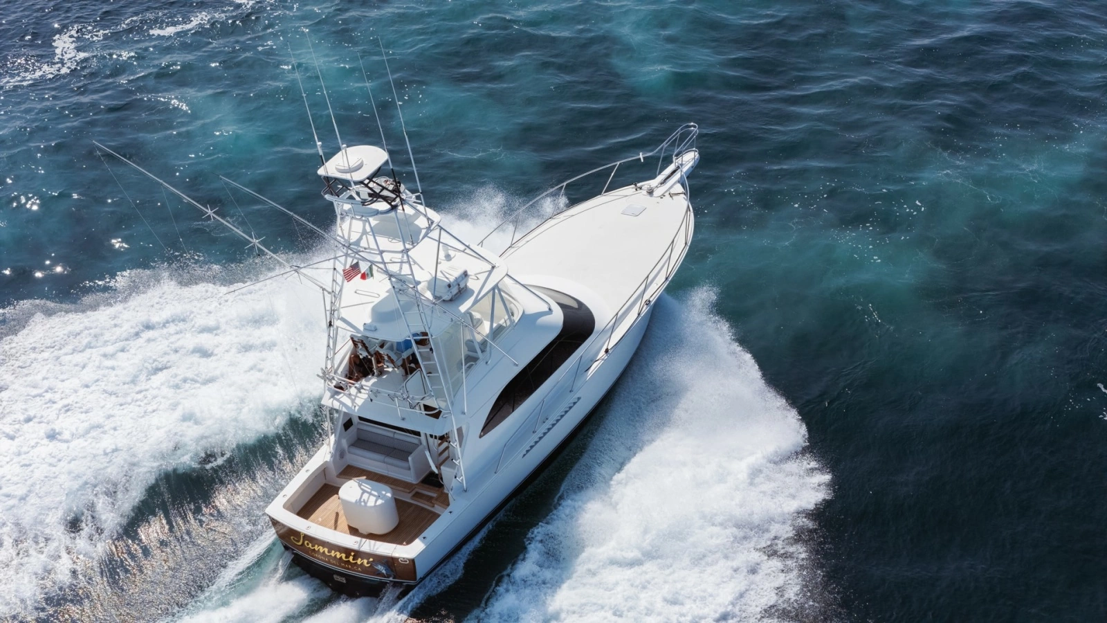 2009 Viking 50 Convertible "Jammin" - Aft-starboard view highlighting the yacht's graceful profile and on-water presence.
