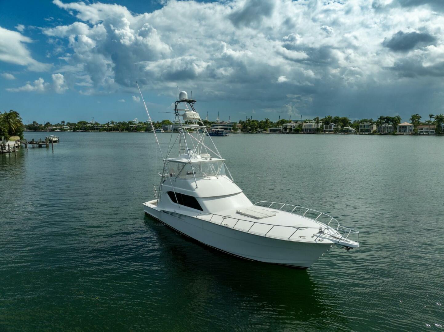 2005 Hatteras 60 Convertible yacht on calm water under cloud