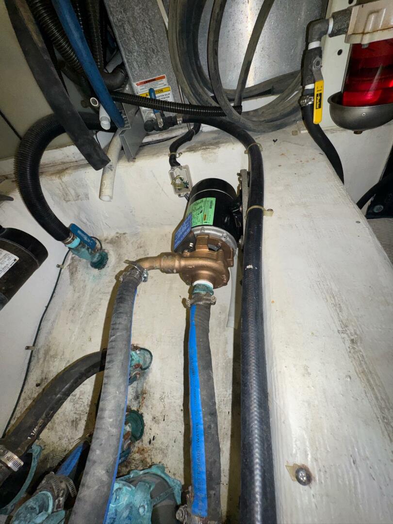 Engine room of 2000 Carver 506 Motor Yacht with visible hose