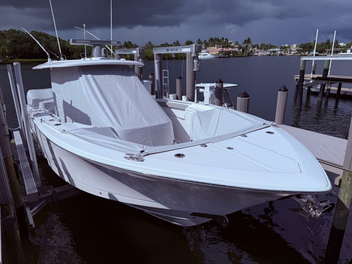 2024 Scout 400 LXF boat docked under cloudy skies.