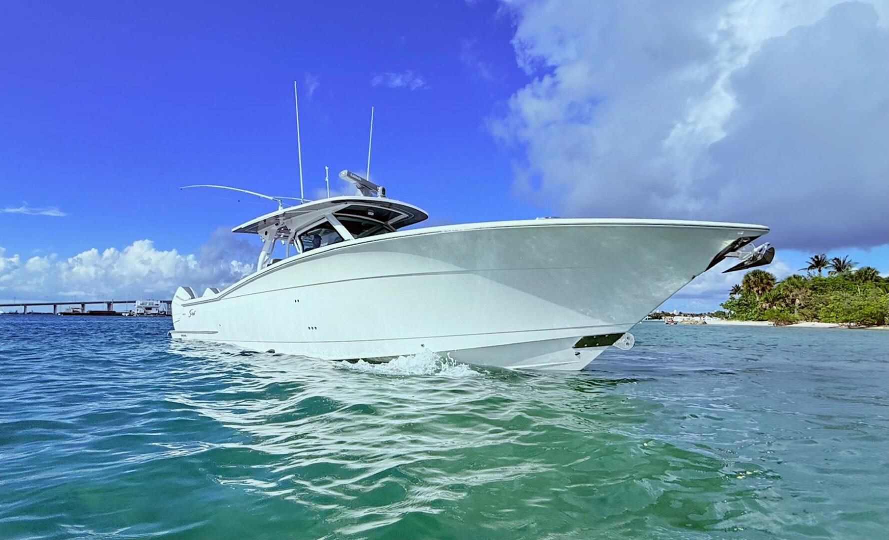 2024 Scout 400 LXF boat cruising in clear blue waters under 