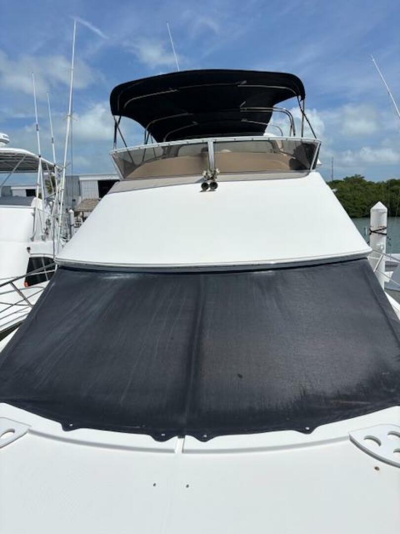 2006 Carver 43 Motor Yacht with black sunshade, docked under