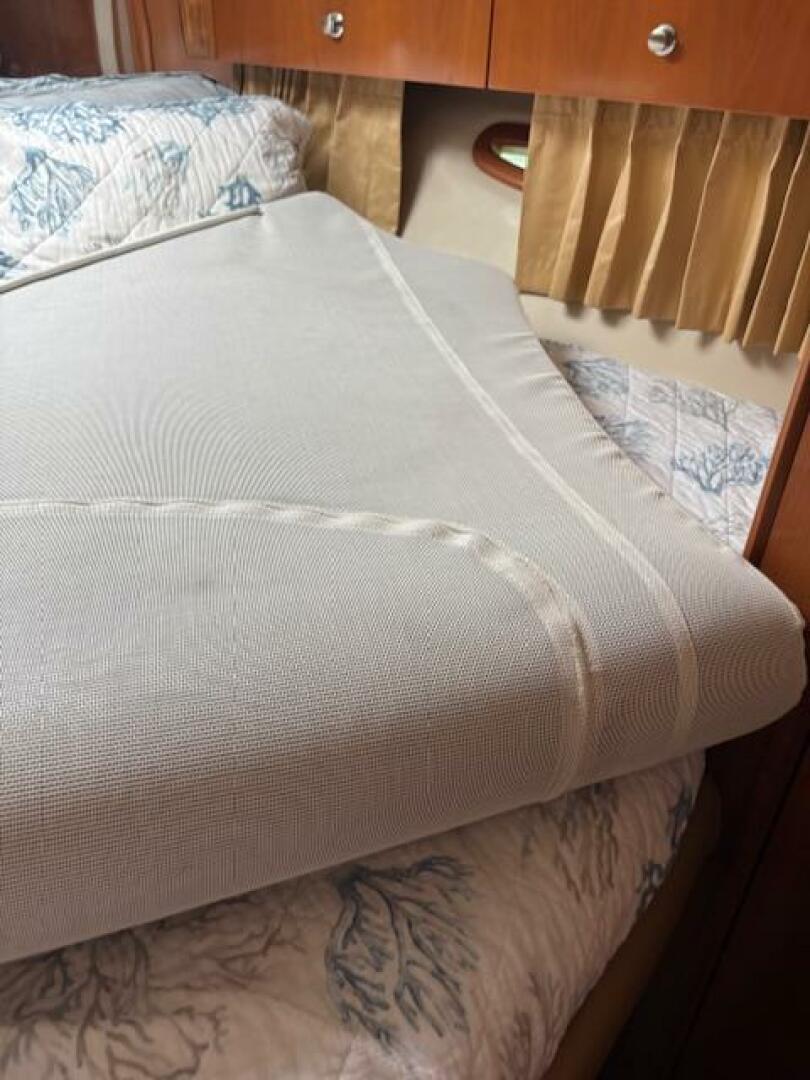 Interior of 2006 Carver 43 Motor Yacht with neatly made bed 