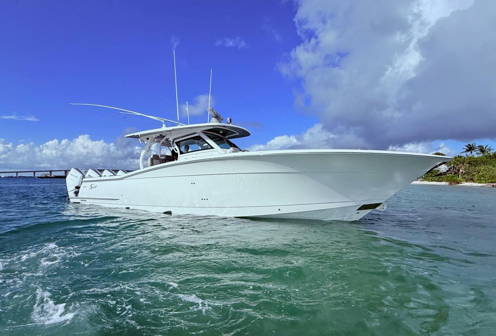 2024 Scout 400 LXF boat on clear blue water under a bright s