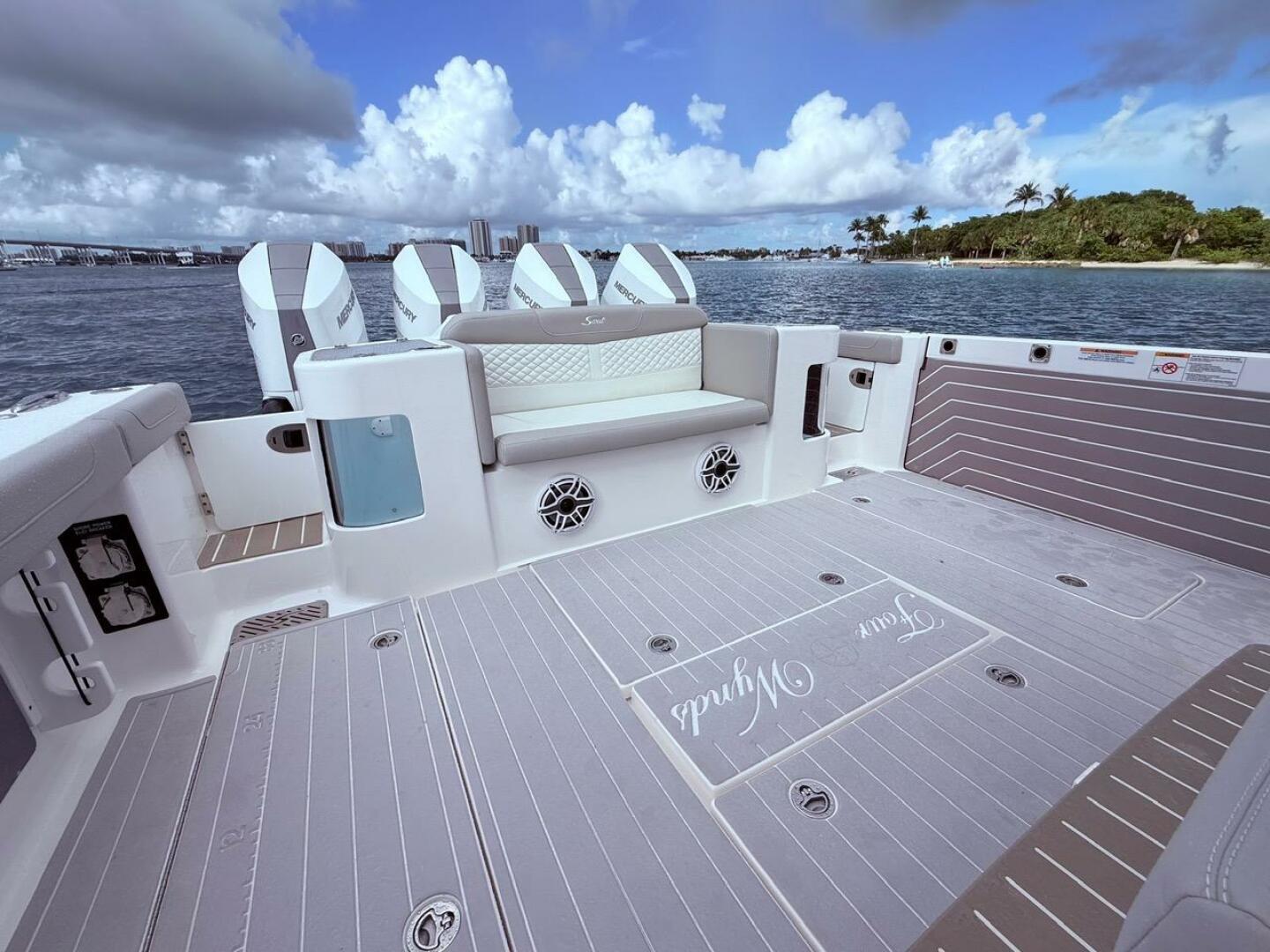 2024 Scout 400 LXF boat deck with seating, ocean view, and c