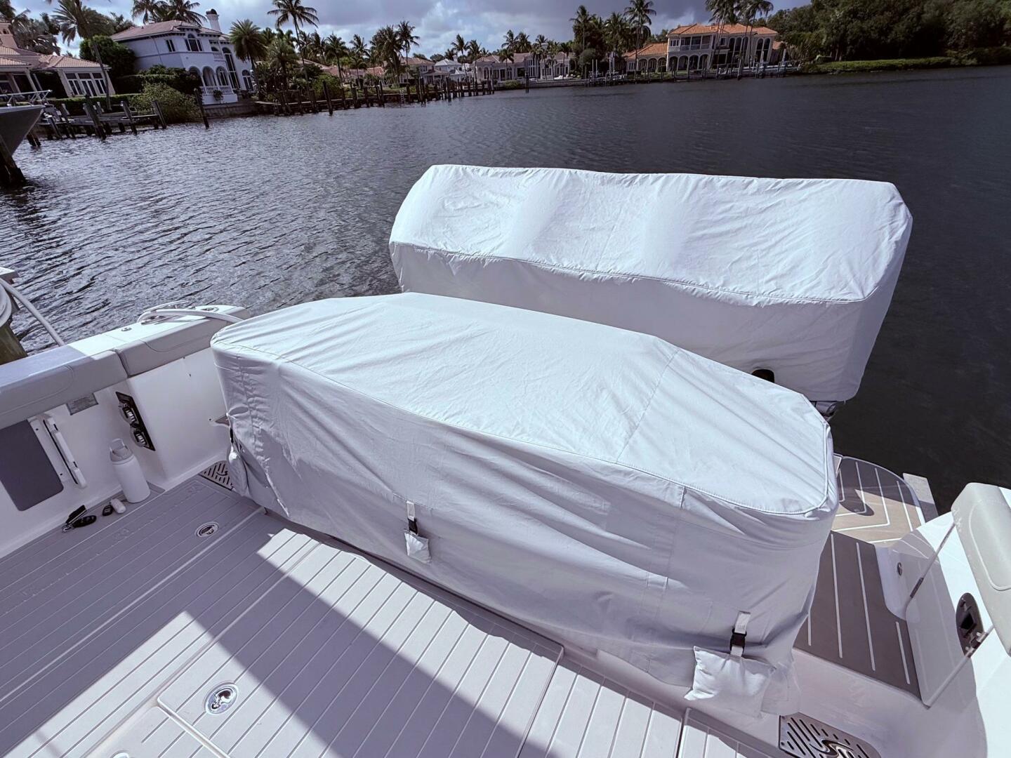 2024 Scout 400 LXF boat with covered engines docked by water