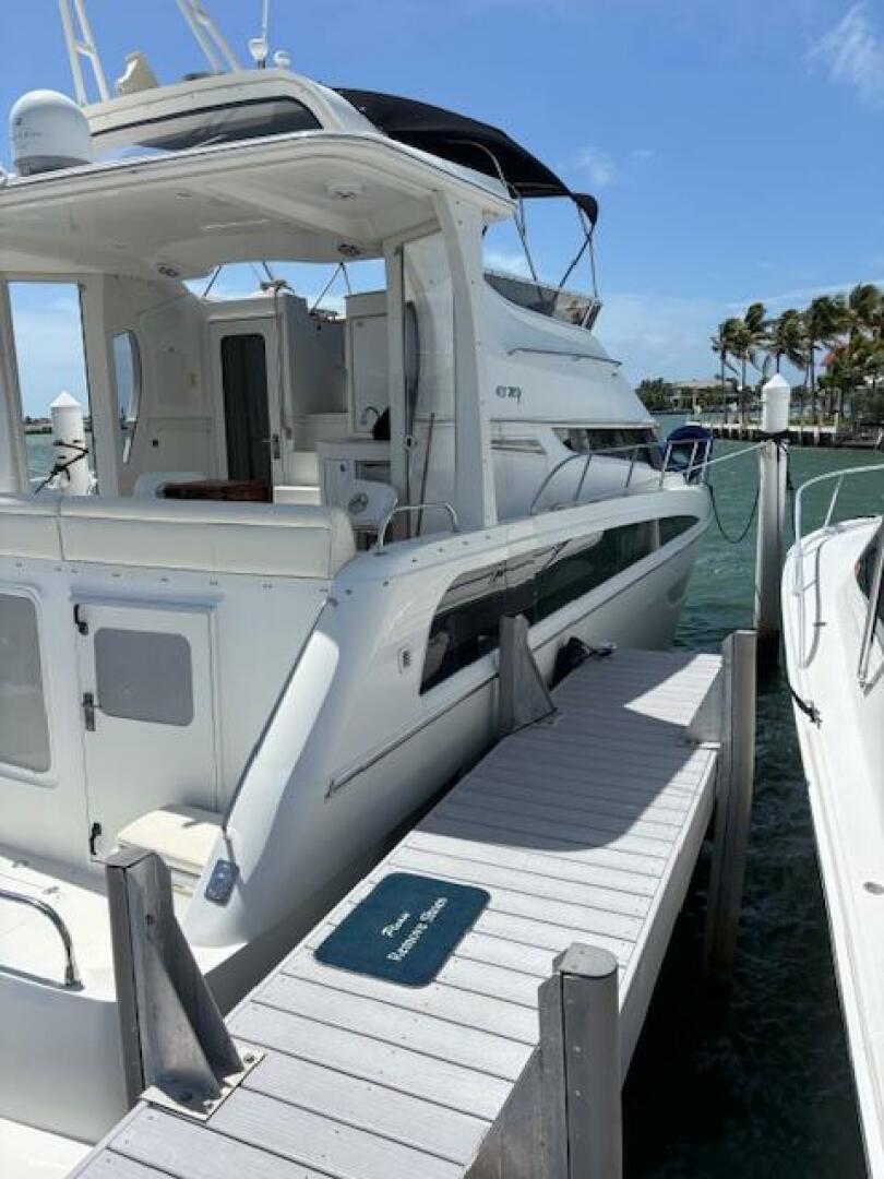 2006 Carver 43 Motor Yacht docked at marina, sunny day, clea