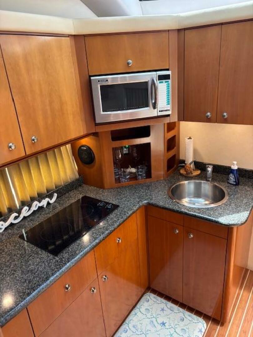 2006 Carver 43 Motor Yacht kitchen with microwave, sink, and