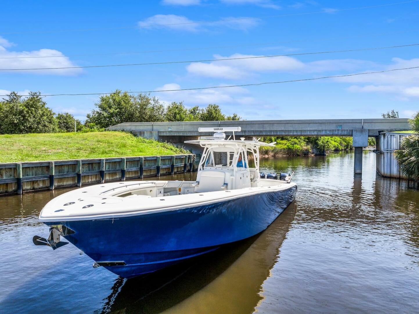 2015 Yellowfin 39 boat cruising on a calm river under a blue