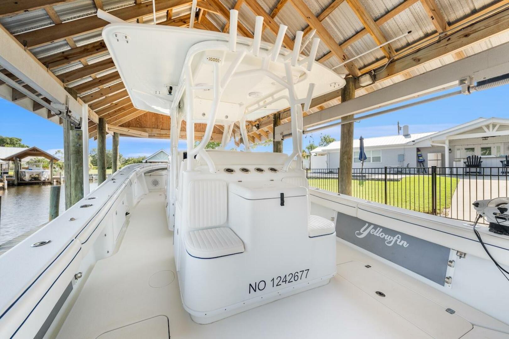 2015 Yellowfin 39 boat docked under a wooden canopy, showcas
