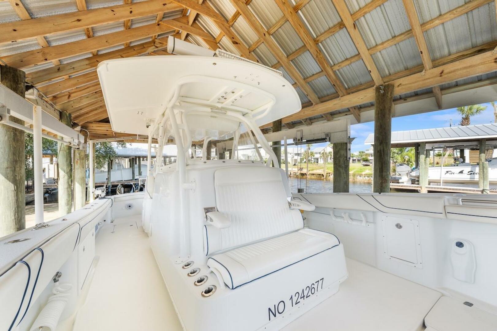 2015 Yellowfin 39 boat docked under wooden shelter, featurin