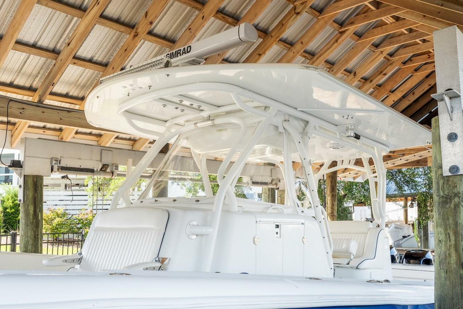 2015 Yellowfin 39 boat under wooden shelter, featuring sleek