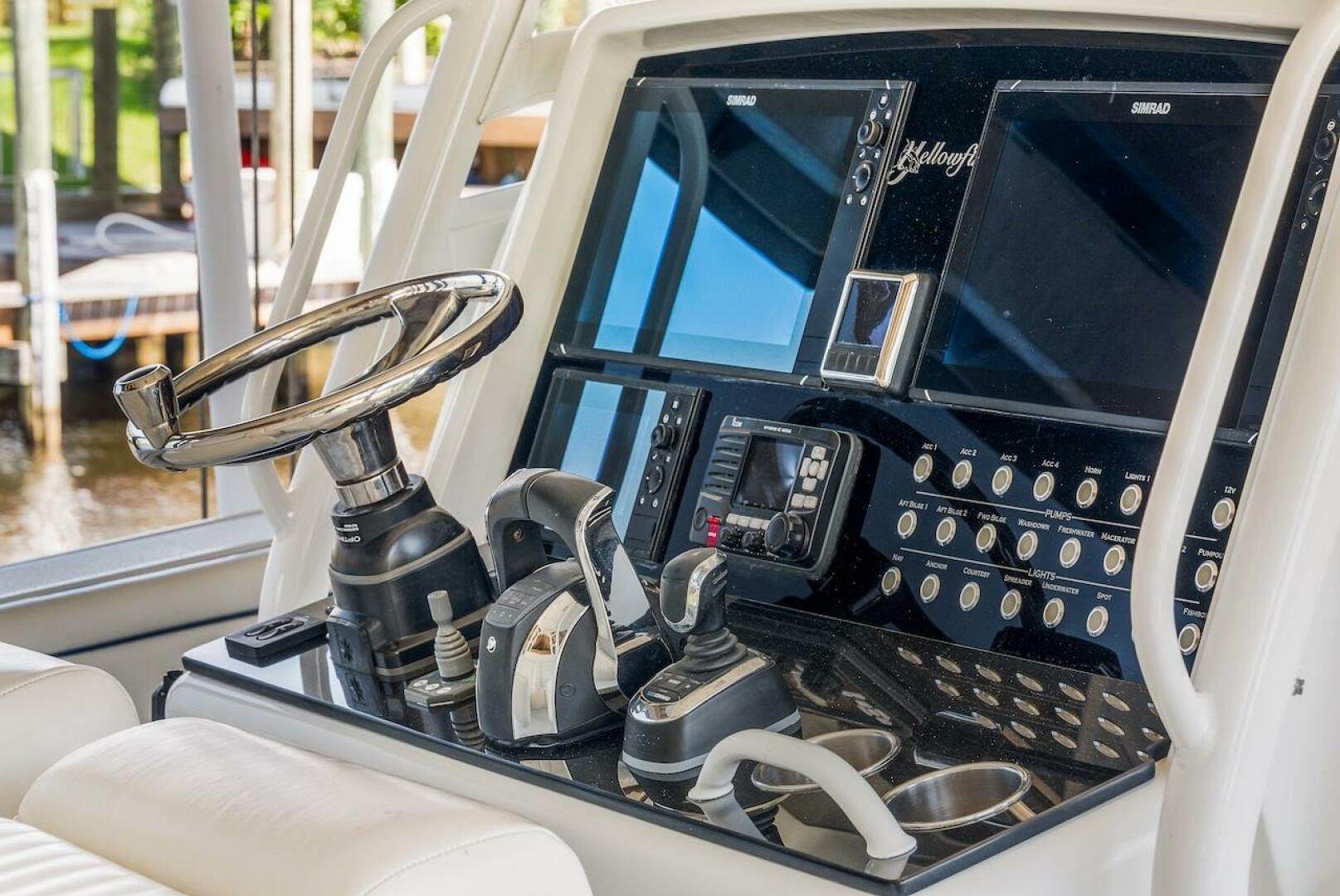 Control panel of a 2015 Yellowfin 39 boat with steering whee