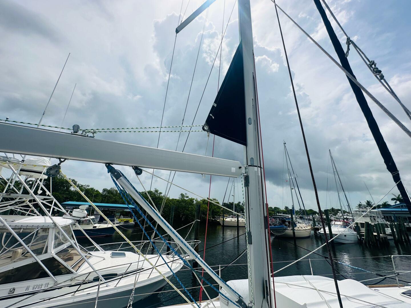 Beneteau Oceanis 45 sailboat docked at marina, cloudy sky, 2
