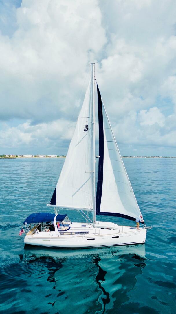 2015 Beneteau Oceanis 45 sailing on calm blue waters under a