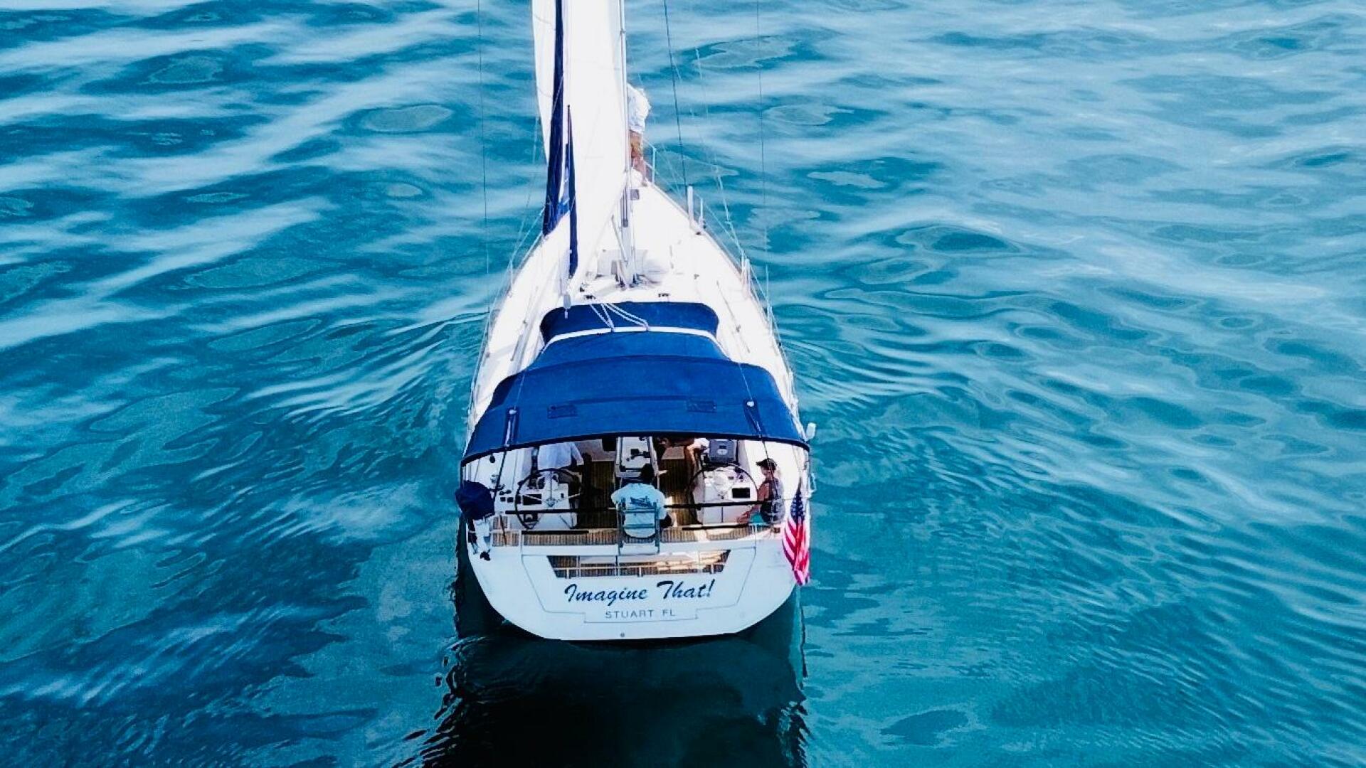 Beneteau Oceanis 45 sailboat on calm blue water, aerial view